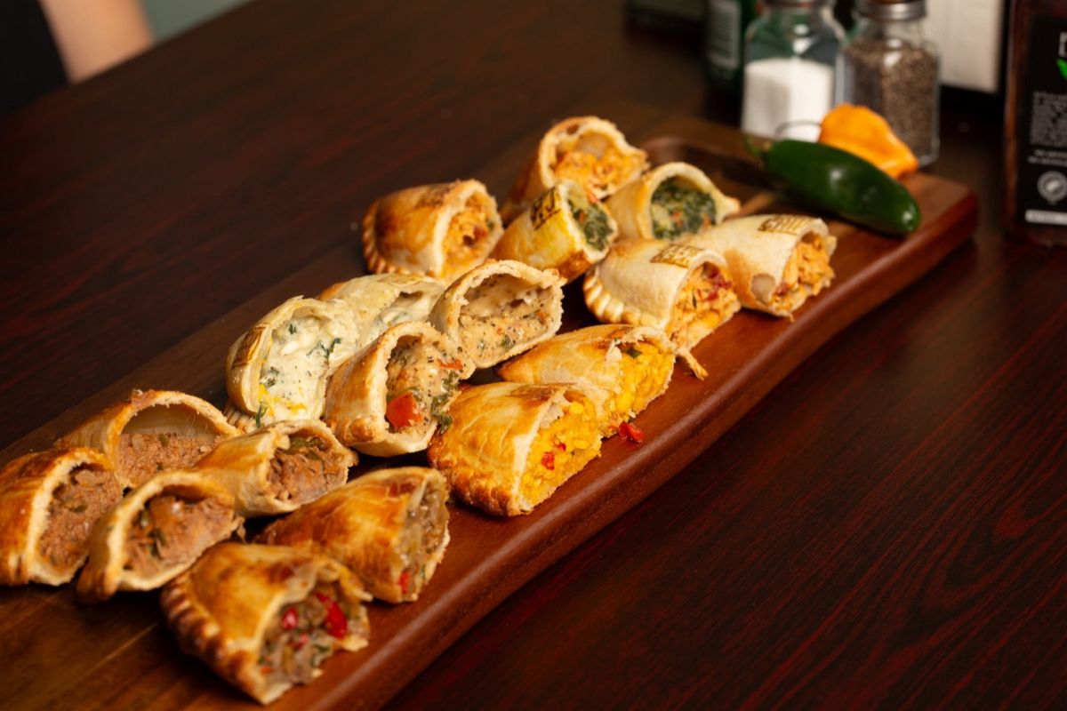 Empanadas cut open on a board showing every filling