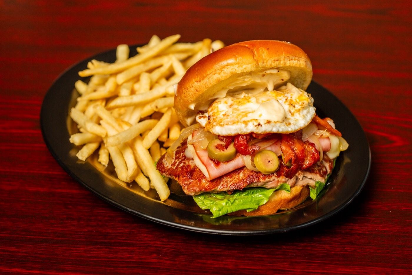 Chivito with a fried egg, served with fries