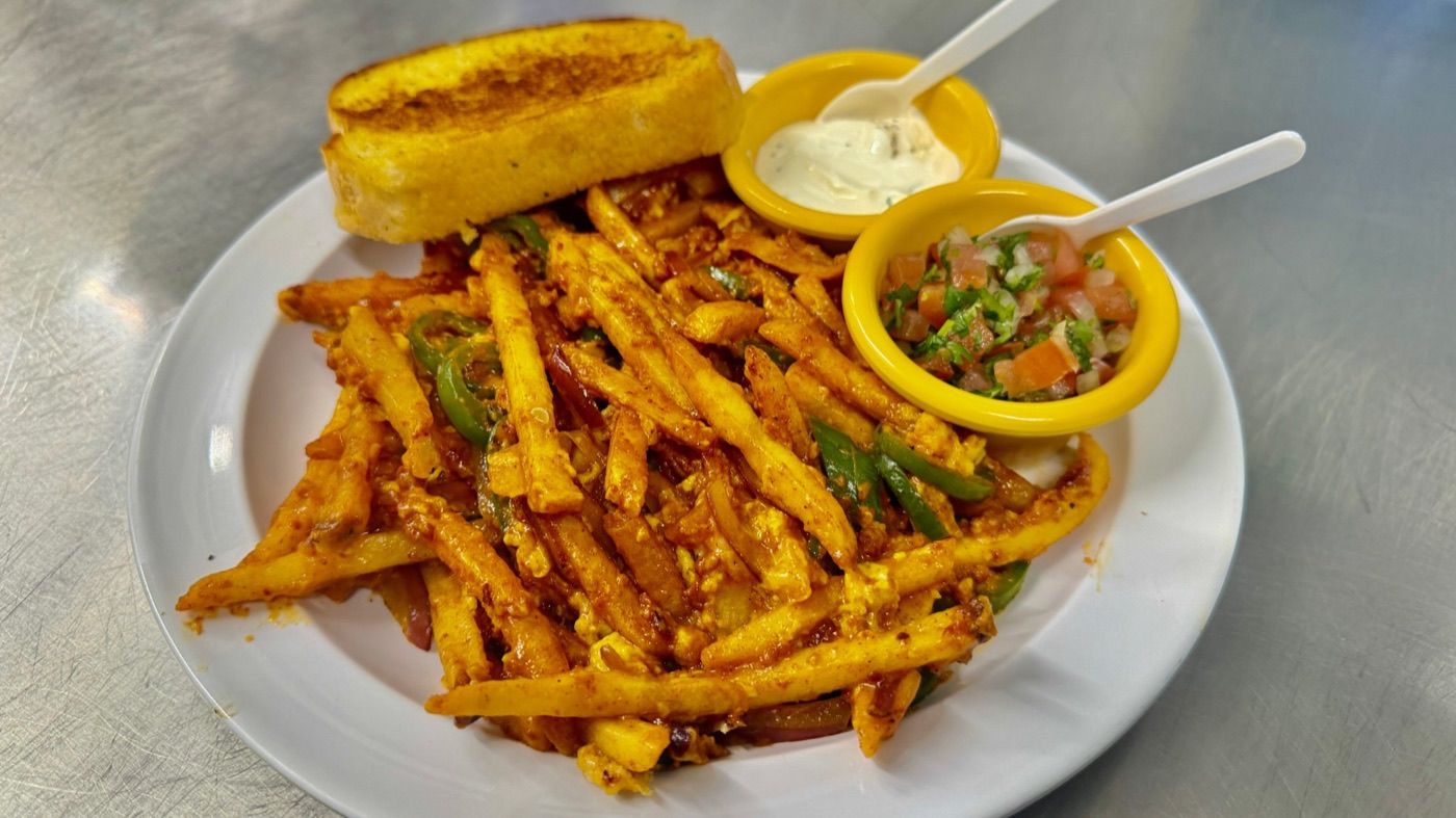 Papas gramajo, fries tossed with pepper, onion and egg, with toasted bread and pico de gallo