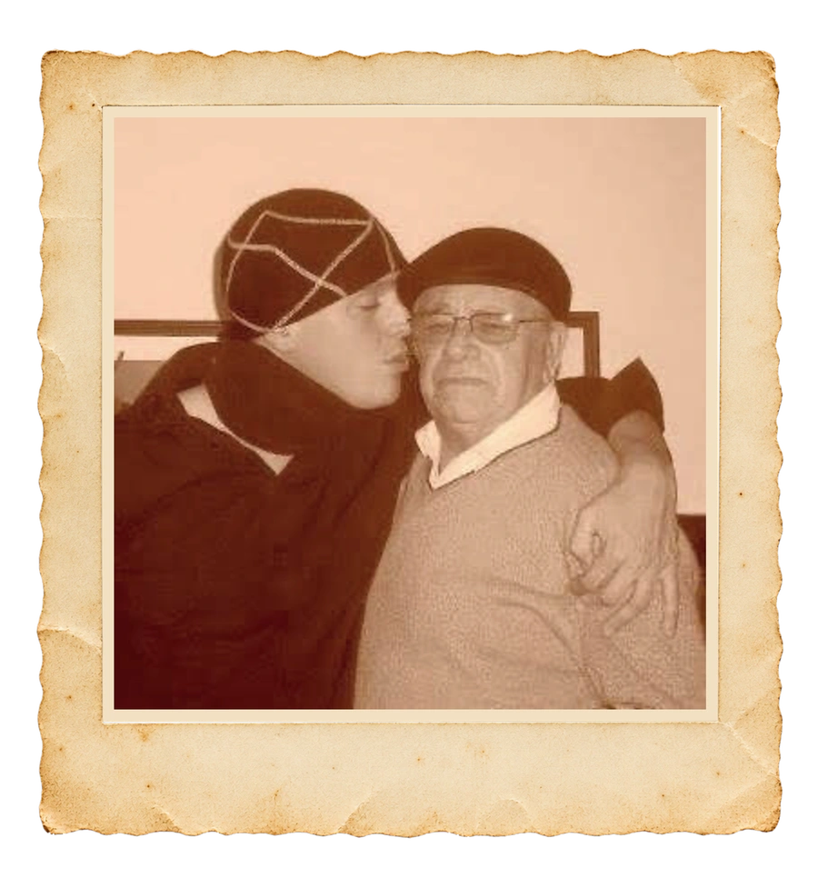 A sepia family photograph of Marcelo kissing his father on the cheek, kept in its paper frame
